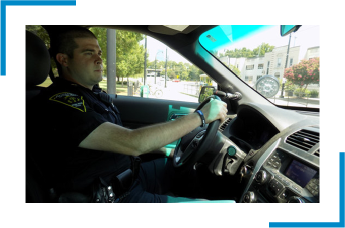 An officer driving a car