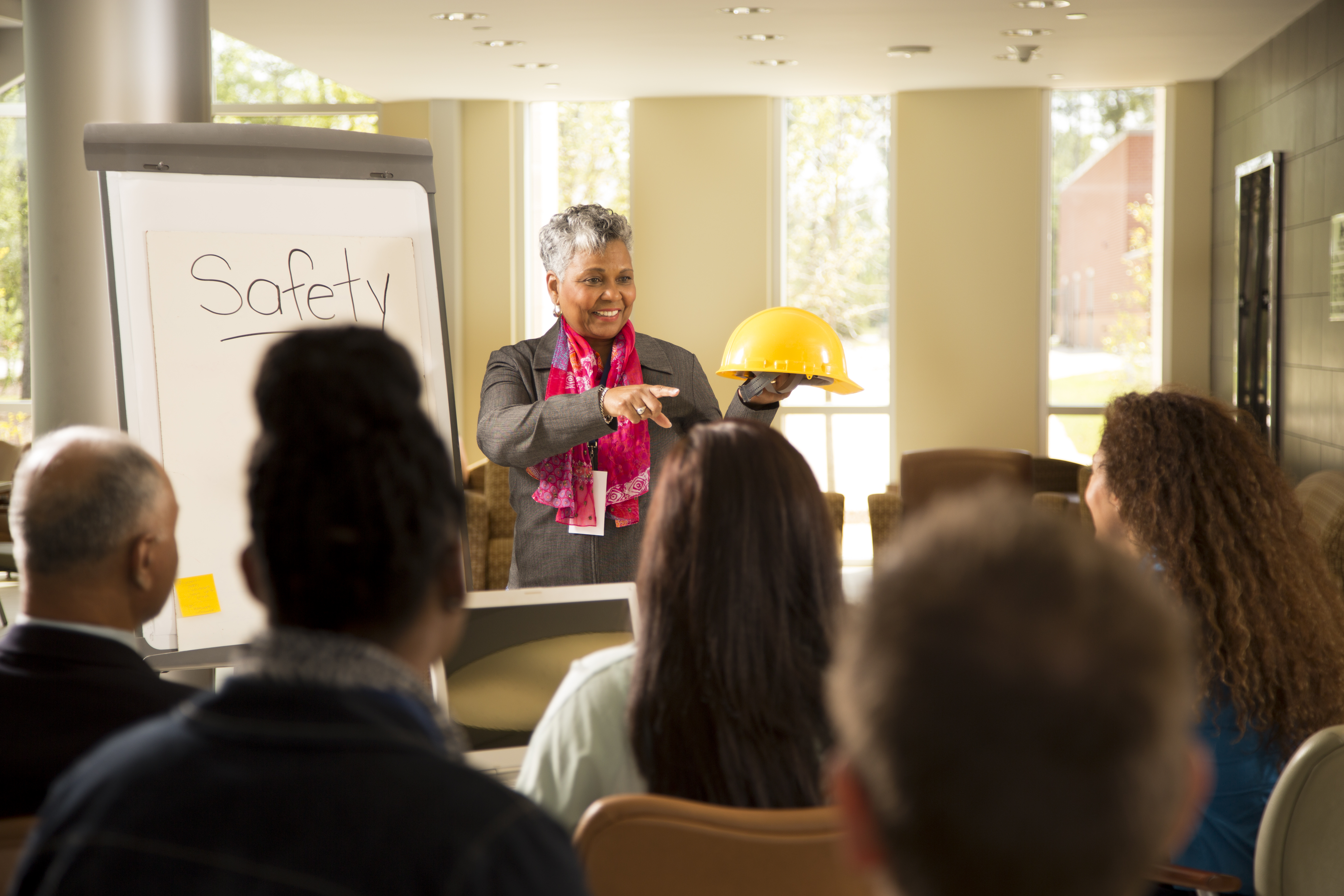 Woman speaking about safety programs in front of a crowd