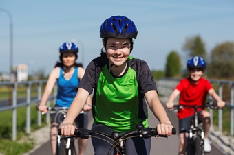 family biking on road