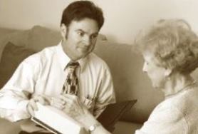 salesman interacting with elderly women 