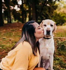 Women kissing Canine