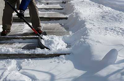 Shoveling snow off of the sidewalk